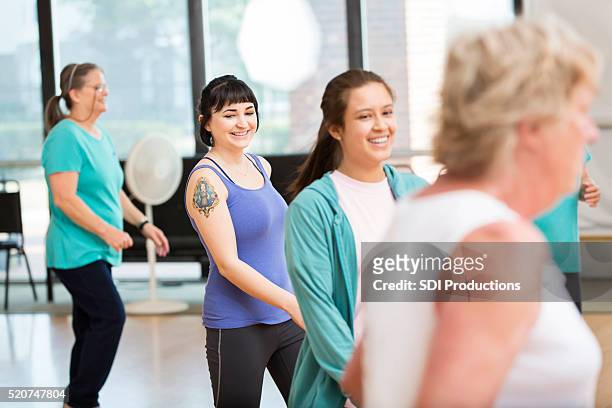 diverse group of women have fun line dancing - line dancing stock pictures, royalty-free photos & images