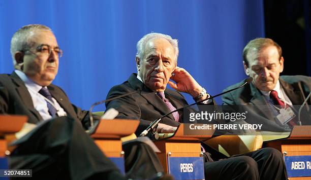 Israeli Vice-Prime Minister Shimon Peres is flanked by Palestinian Minister of Finance Salam Fayyad and former Palestinan Minister Abed Rabbo during...