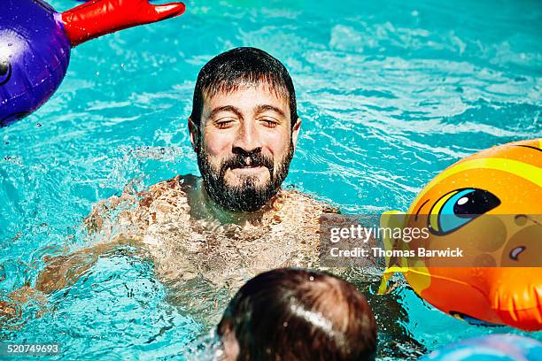 smiling man emerging from underwater in pool - caucasian appearance photos stock pictures, royalty-free photos & images