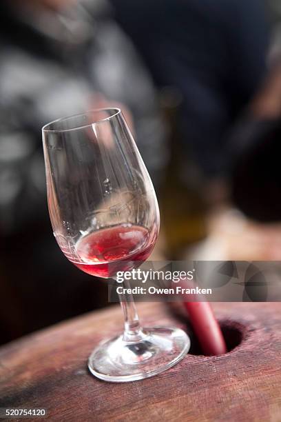 glass of red wine, sitting on a barrel - paris - beaujolais nouveau stock pictures, royalty-free photos & images