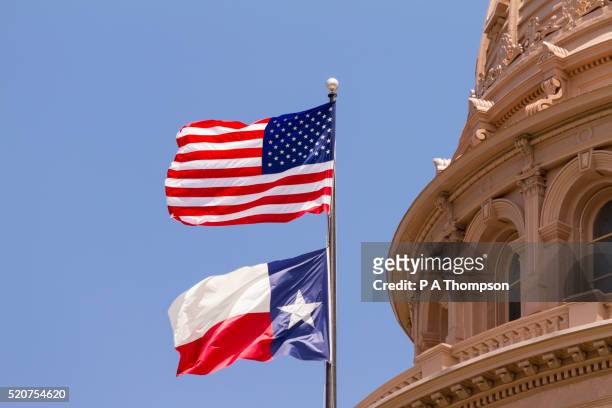 flags, texas state capitol building, austin - texas stock pictures, royalty-free photos & images
