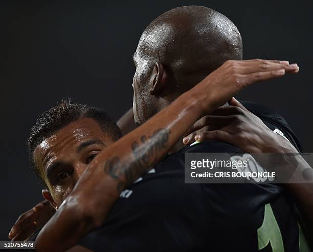 Colombia's Atletico Nacional player Victor Ibarbo celebrates with teammate Macnelly Torres after scoring against Peru's Sporting Cristal during their...