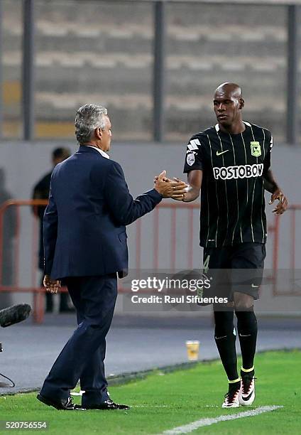 Victor Ibarbo of Atletico Nacional celebrates with his coach Reynaldo Rueda the first goal of his team against Sporting Cristal during a match...