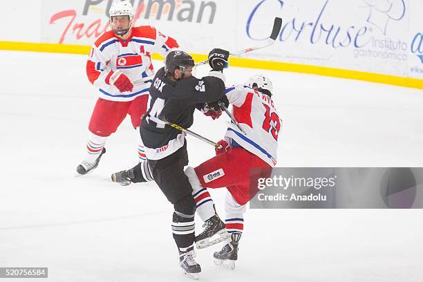 Andrew Cox of New Zealand and Hyok Ju Kim of Korea in action during a match between New Zealand and Korea as part of the 2016 IIHF Ice Hockey World...