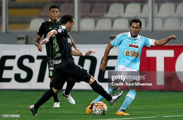 Carlos Lobaton of Sporting Cristal struggles for the ball with Alejandro Guerra of Atletico Nacional during a match between Sporting Cristal and...