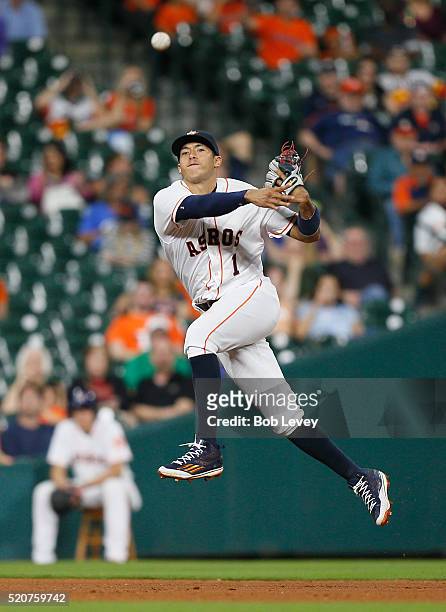 Carlos Correa of the Houston Astros throws to first base to retire Omar Infante of the Kansas City Royals in the seventh inning at Minute Maid Park...
