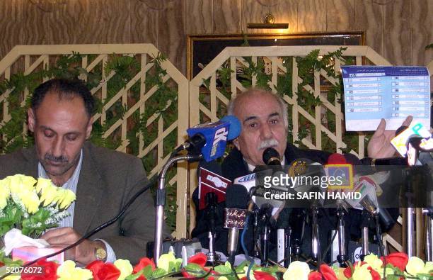Kamal Ghambar , head of electoral commission in the northern Iraqi Kurdish city of Arbil holds up a voting list during a press conference in Arbil,...