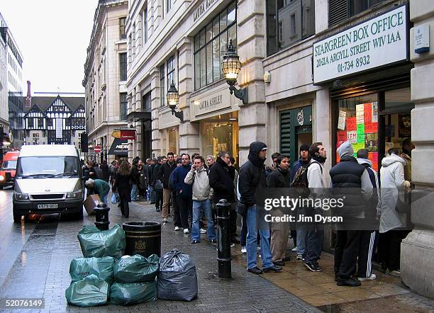 Fans queue to buy U2 tickets, at the Stargreen Box Office, for the group's Twickenham concerts in June, January 28, 2005 in Central London.