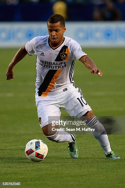 Giovani dos Santos of Los Angeles Galaxy dribbles the ball against the Portland Timbers during the first half of their MLS match at StubHub Center on...