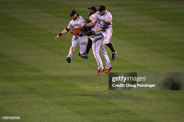 Angel Pagan, Denard Span and Hunter Pence of the San Francisco Giants celebrate their 7-2 victory over the Colorado Rockies at Coors Field on April...