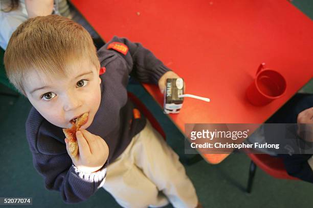 Three-year-old boy eats a sandwich at a private nursery school January 28, 2005 in Glasgow, Scotland. The average price of pre-school care has...