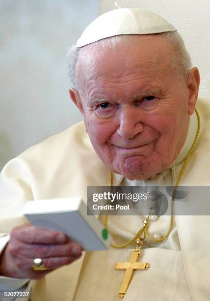 Pope John Paul II gives a present to the President of the Republic of Armenia Robert S.Kocharian during their meeting on January 28, 2005 in Vatican...