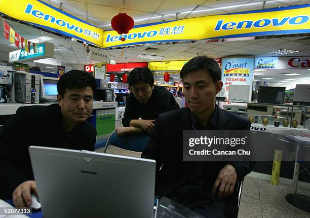 Salesmen use a Lenovo laptop at a store January 28, 2005 in Beijing, China. China's biggest PC maker Lenovo's deal to buy the personal computer...