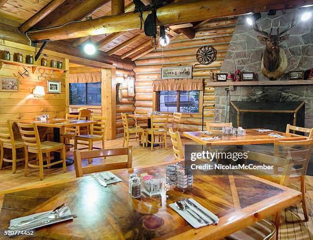 american western log cabin restaurant dining room with fireplace - inn stock pictures, royalty-free photos & images