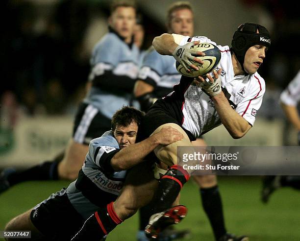 Simon Webster of Edinburgh is tackled by Tristan Davies of Cardiff during the Celtic league match between Cardiff Blues and Edinburgh at Cardiff Arms...