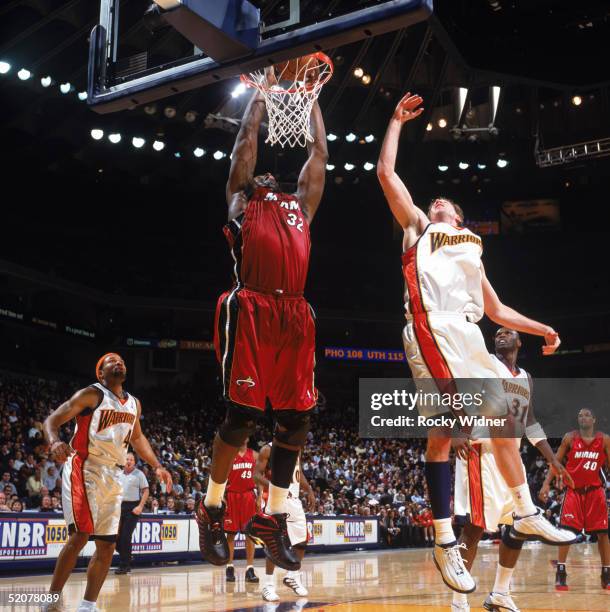 Shaquille O'Neal of the Miami Heat dunks during a game against the Golden State Warriors at The Arena in Oakland on January 12, 2005 in Oakland,...