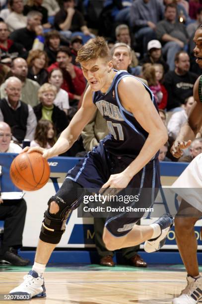 Andrei Kirilenko of the Utah Jazz drives to the basket around Latrell Sprewell of the Minnesota Timberwolves on January 28, 2005 at the Target Center...