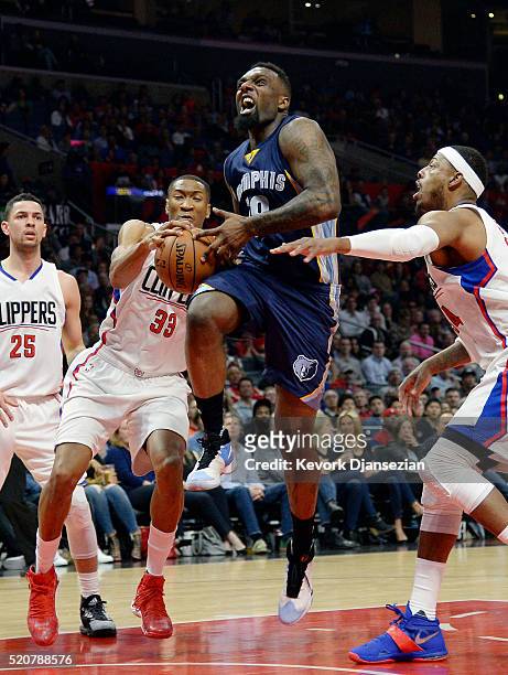 Wesley Johnson of the Los Angeles Clippers strips the ball from P.J. Hairston of the Memphis Grizzlies during the first half of the basketball game...