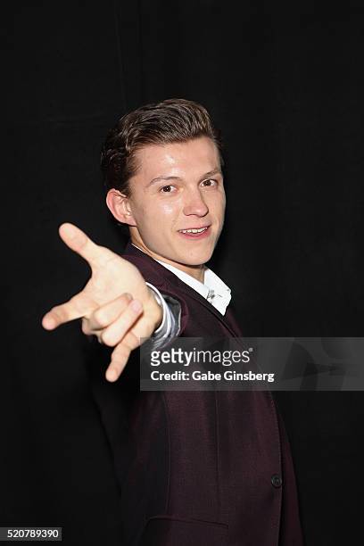 Actor Tom Holland poses like Spider-Man during CinemaCon 2016 An Evening with Sony Pictures Entertainment: Celebrating the Summer of 2016 and Beyond...