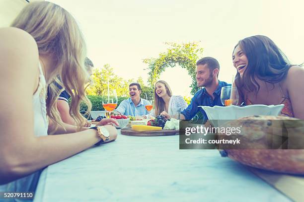 group of young people eating outdoors. - wide angle stock pictures, royalty-free photos & images