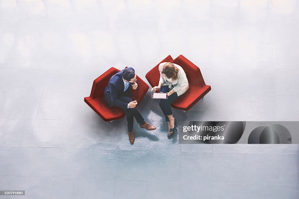 Overhead view of two business persons in the lobby