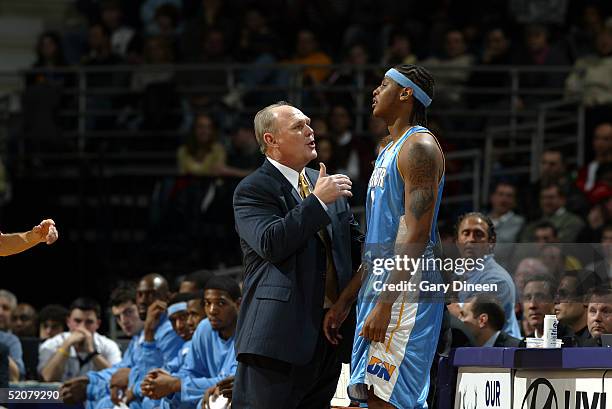 Head coach George Karl of the Denver Nuggets talks with Carmelo Anthony during a game against the Milwaukee Bucks at the Bradley Center on January...