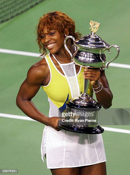 Serena Williams of the USA holds the trophy aloft after winning the Women's Final against Lindsay Davenport of the USA during day thirteen of the...