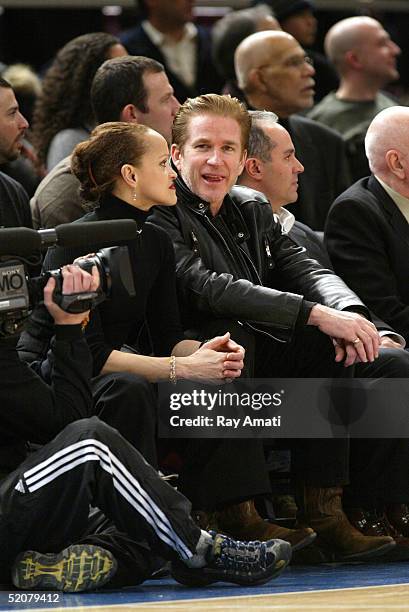 Actor Matthew Modine and his wife Caridad Rivera sit courtside during the Cleveland Caveliers v New York Knicks NBA game at Madison Square Garden on...