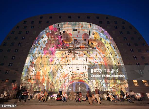 people in front of the markthal, rotterdam at dusk - rotterdam market stock pictures, royalty-free photos & images