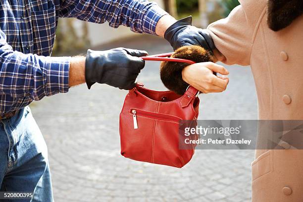 mugger stealing handbag - handtasche stock-fotos und bilder