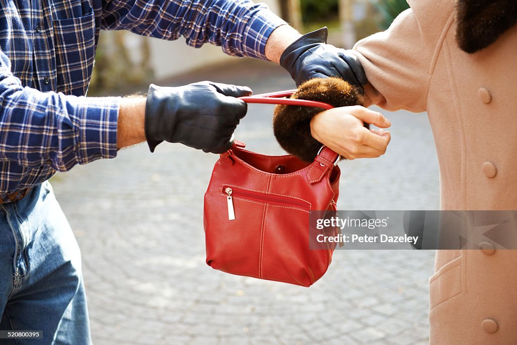 Mugger stealing handbag