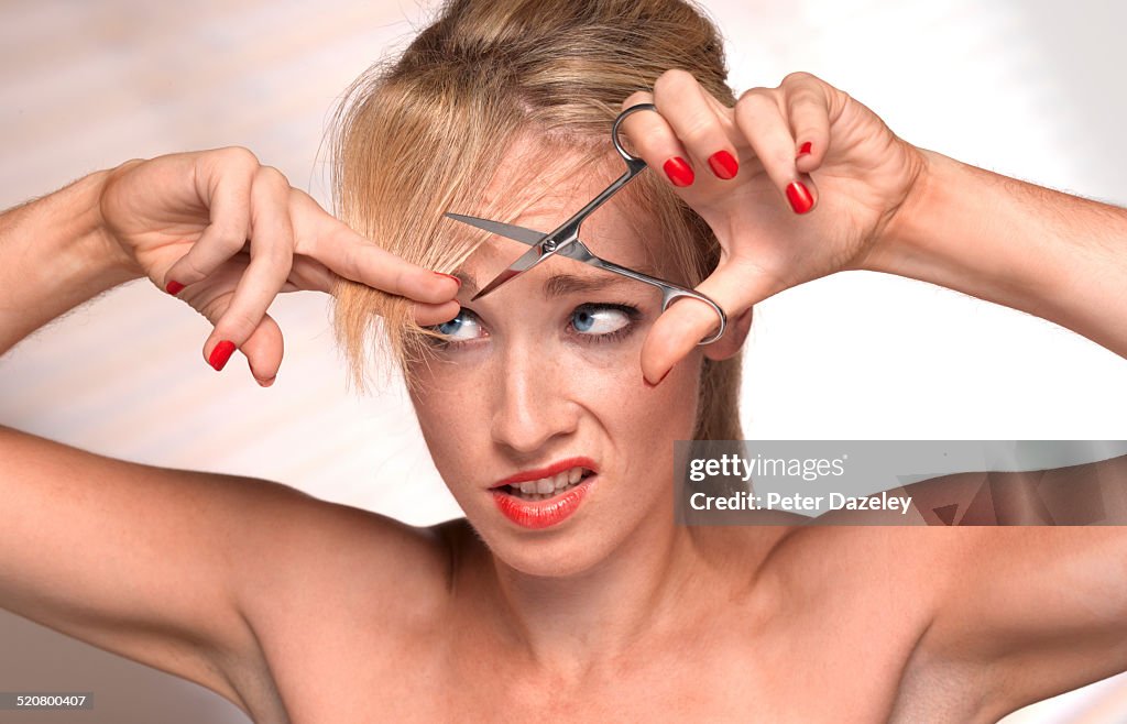 Girl cutting own hair