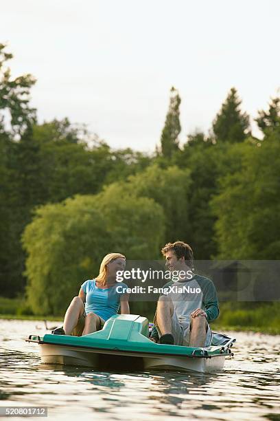 couple on a lake - paddleboat stock pictures, royalty-free photos & images