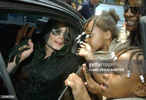 This 06 July file photo shows pop singer Michael Jackson waving from his limo to fans in the Harlem neighborhood of New York. The child molestation...