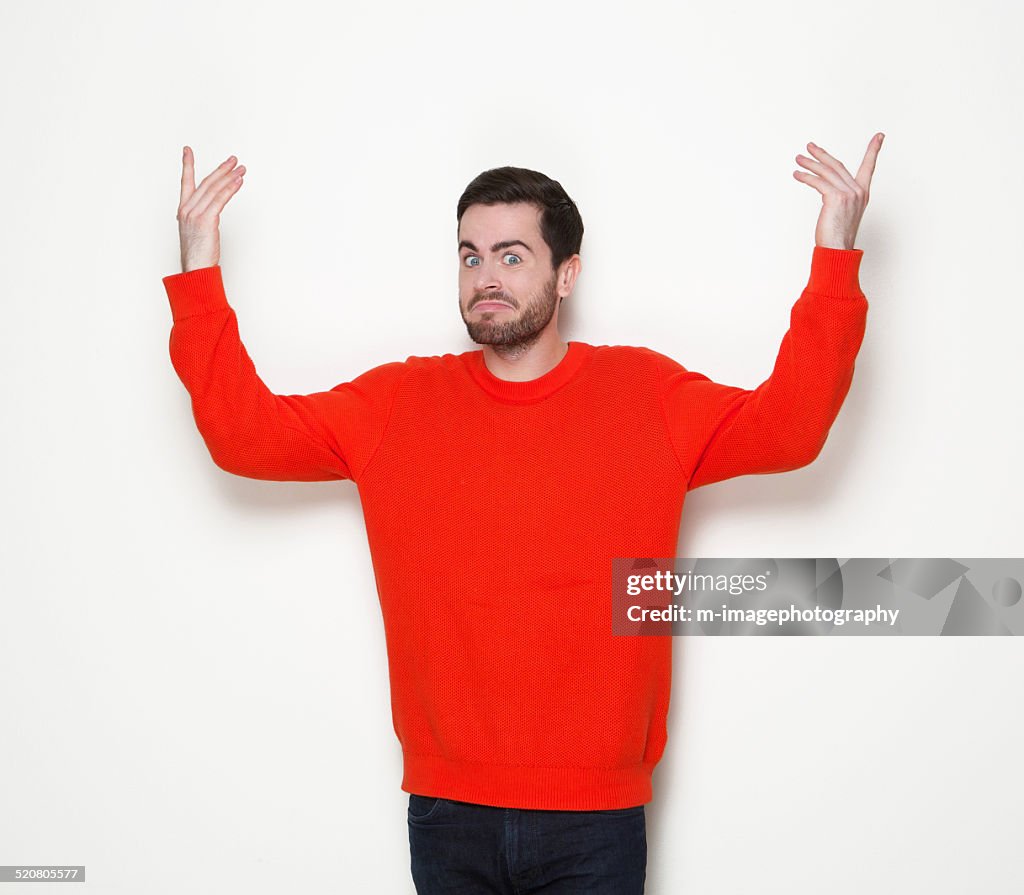 Man with beard with arms raised