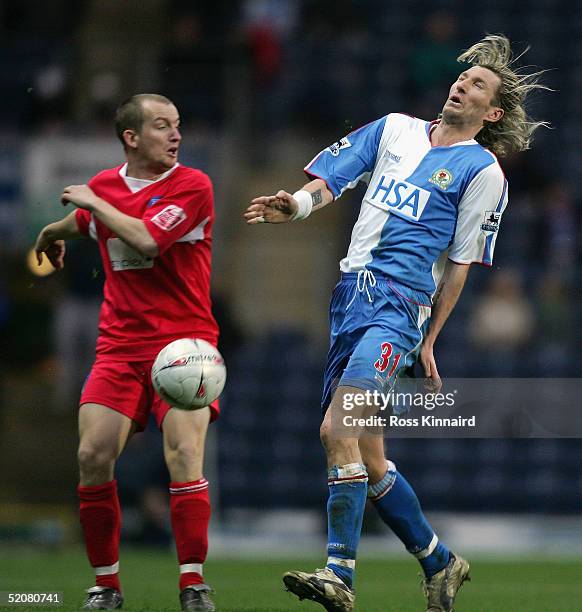 Joe Keith of Colchester challenges Robbie Savage of Blackburn during the FA Cup forth round tie between Blackburn Rovers and Colchester United at...