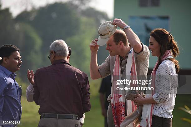 Britain's Prince William, Duke of Cambridge and Catherine, Duchess of Cambridge are greeted by Indian forest official before leaving for a jeep...