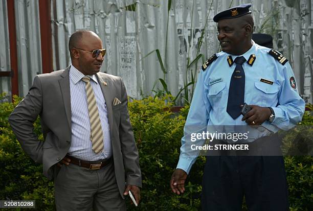 Alain-Guillaume Bunyoni, Burundian Minister of Security talks with a police officer in Bujumbura on April 12, 2016. A year after Burundi was plunged...