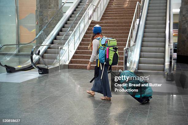 young woman with backpack and luggage at airport - anchorage airport stock pictures, royalty-free photos & images