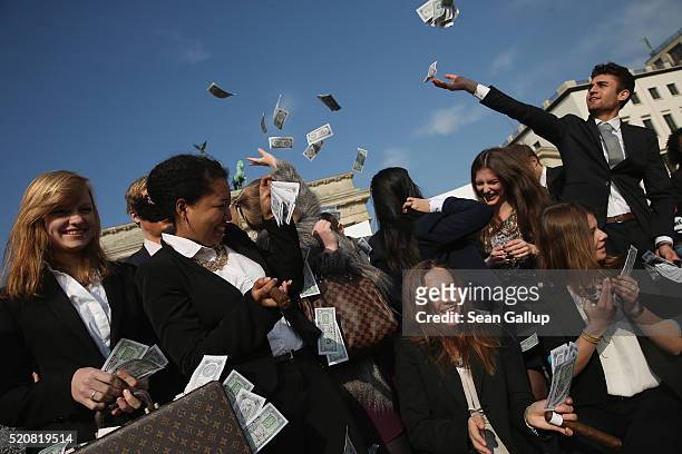 Activists wearing suits throw fake money into the air while demanding greater trasparency in new legislation following the ongoing Panama Papers...