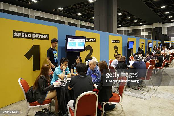 Members of startups meet with potential investors or mentors in the 'speed dating' area at the Tech in Asia conference in Singapore on Wednesday,...