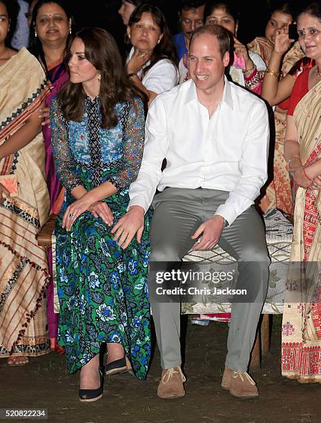 Catherine, Duchess of Cambridge and Prince William, Duke of Cambridge watch dancing by the fireside during a Bihu Festival Celebration at Diphlu...