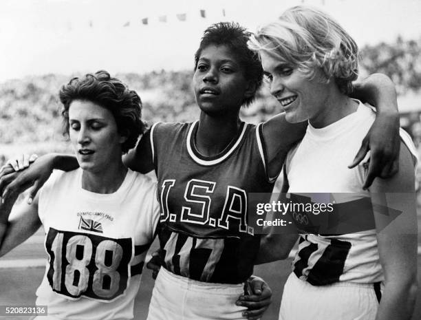 Nicknamed "the black gazelle", U.S champion Wilma Rudolph , who have just won the Olympic 200m event, pose between German Jutta Heine , who finished...
