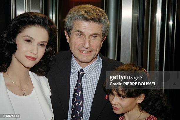 French director Claude Lelouch pose on March 17, 1992 with his wife actress Alessandra Martines and his daughter Salomé for the premiere of the film...