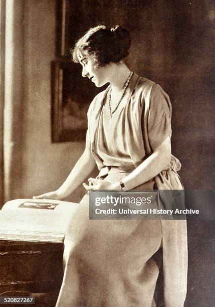 Lady Elizabeth Bowes Lyon is shown reading a book at Glamis Castle, Scotland.