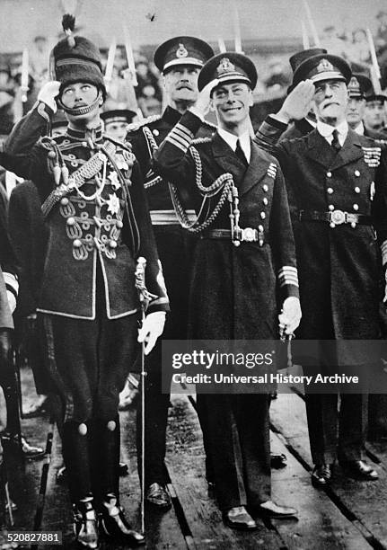 The Prince of Wales returning from an Imperial Tour. The Duke of York , Prince Henry and the Guard of Honour stand in the pouring rain, waiting for...