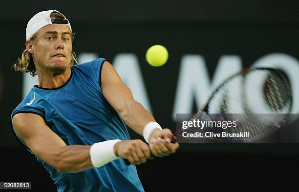 Lleyton Hewitt of Australia hits a backhand against Marat Safin of Russia during the Men's Final during day fourteen of the Australian Open Grand...