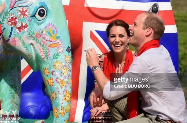 Britain's Prince William , Duke of Cambridge, and Catherine , Duchess of Cambridge, paint an elephant statue at Kaziranga Discovery Park in Panbari...