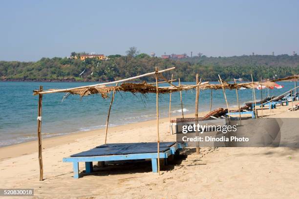 wooden beds on sand at keri beach in pernem, canacona, goa, india - goa beach stock-fotos und bilder