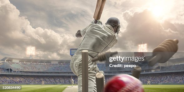Rear View Of Cricket Ball Hitting Stumps Behind Batsman Rear View Of Cricket Ball Hitting Stumps Behind Batsman
